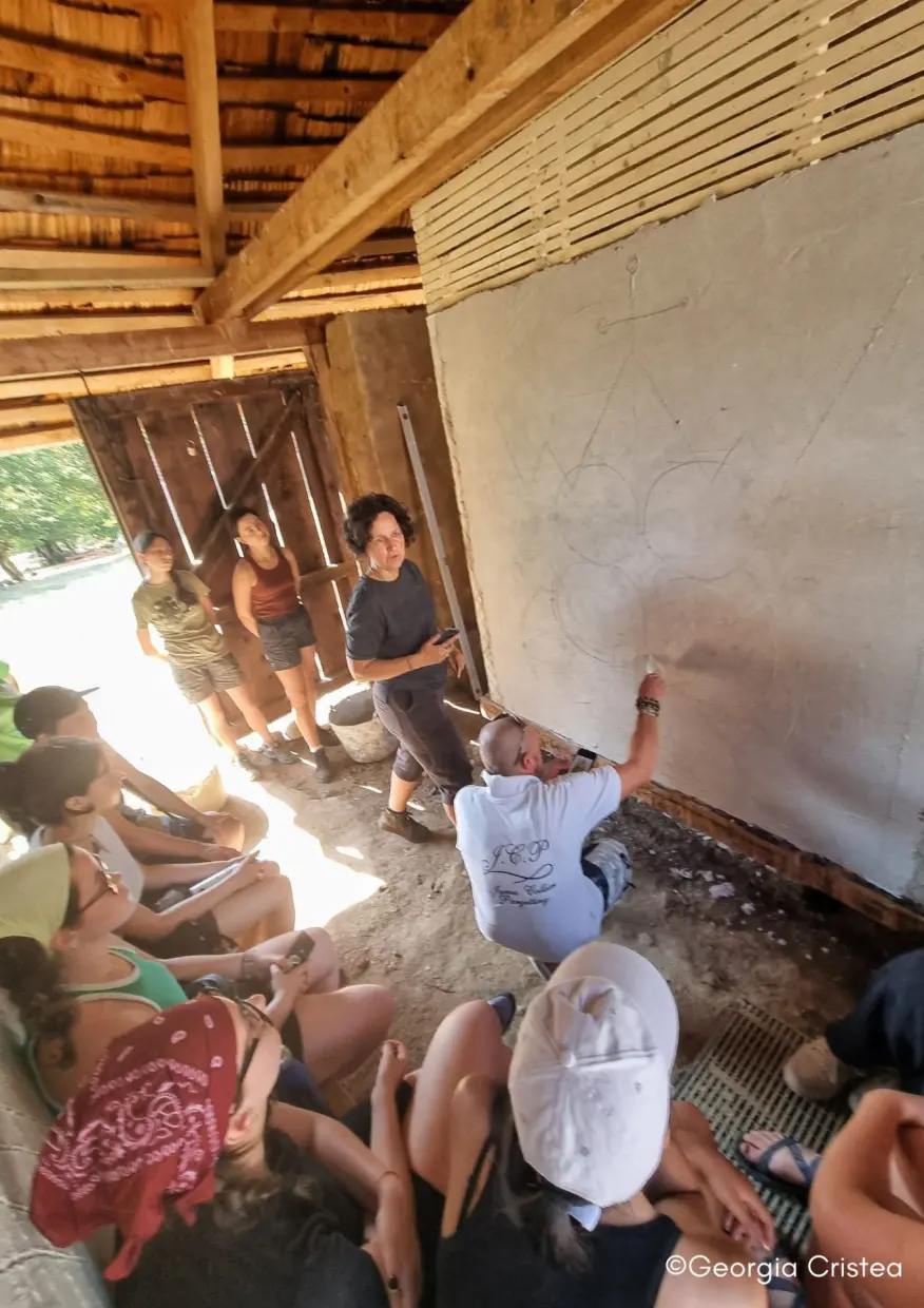 James Collier and Ana-Maria Goilav etching the design on the wet plaster, working in the microclimate ten